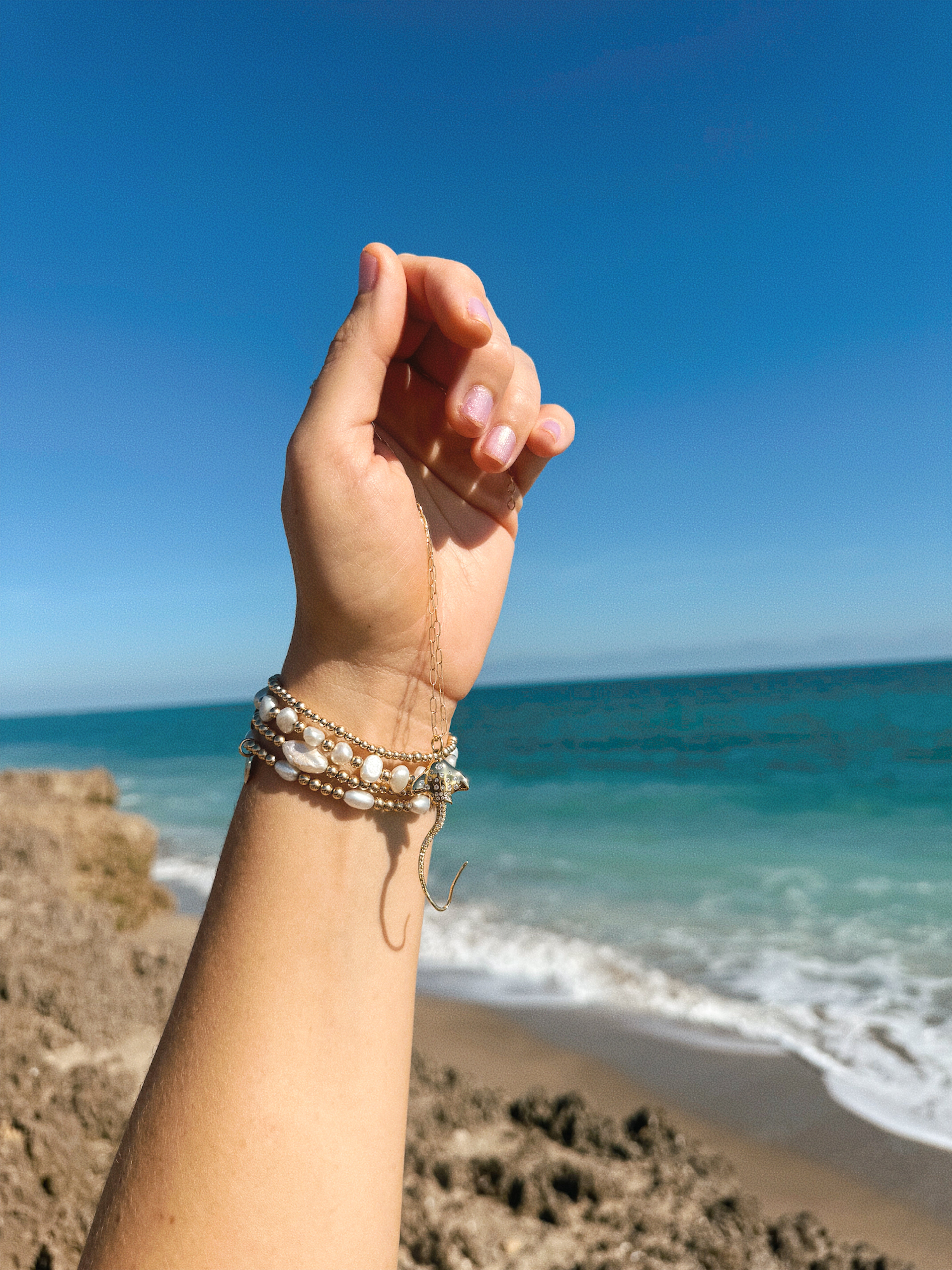 Hihimanu Spotted Eagle Ray Gold Charm Necklace Wrapped on Hand