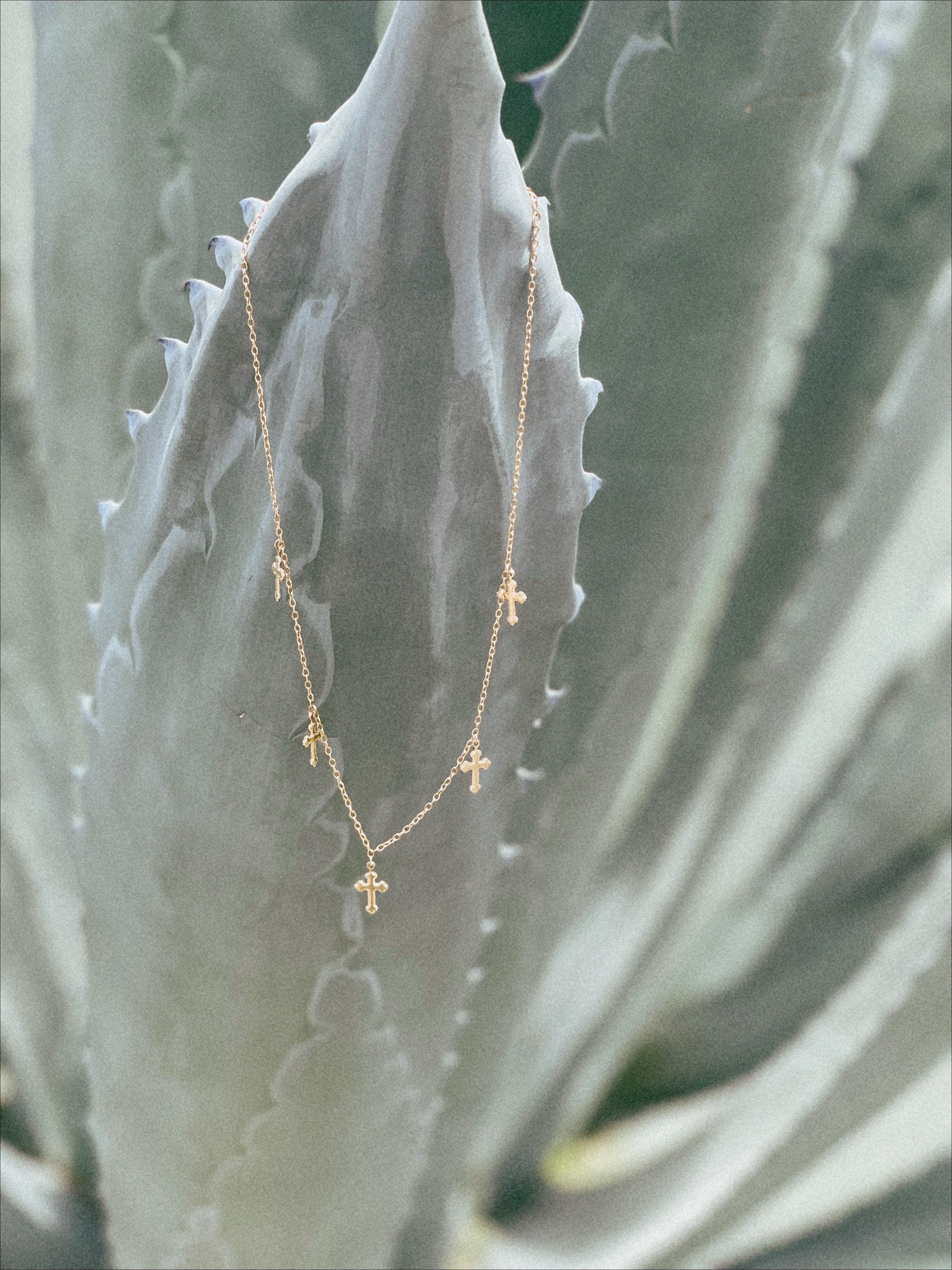 Faith 5 Gold Filled Crosses on Gold Chain Necklace On Plant