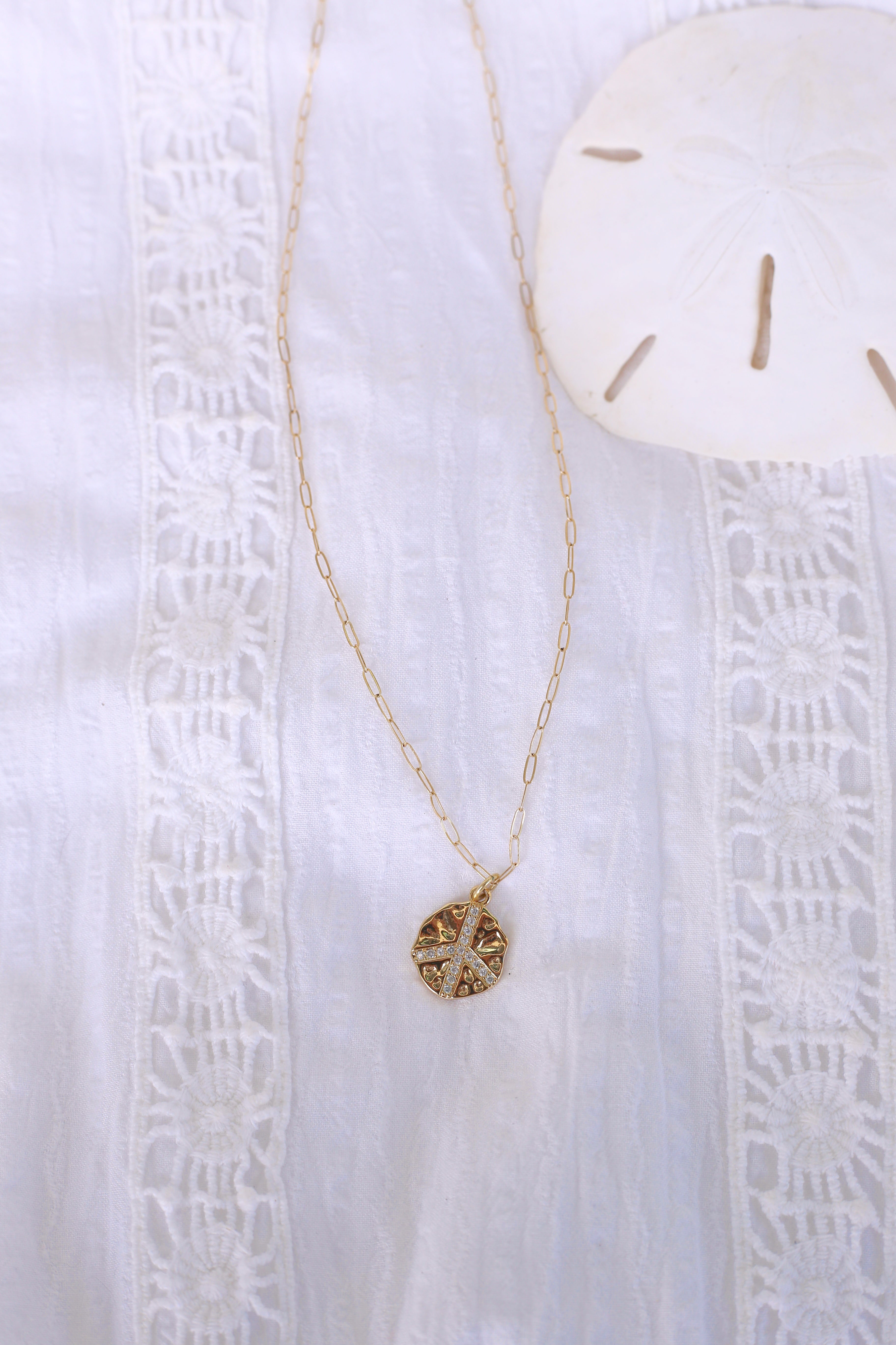 Gold Peace Sign Charm Necklace Flat Lay