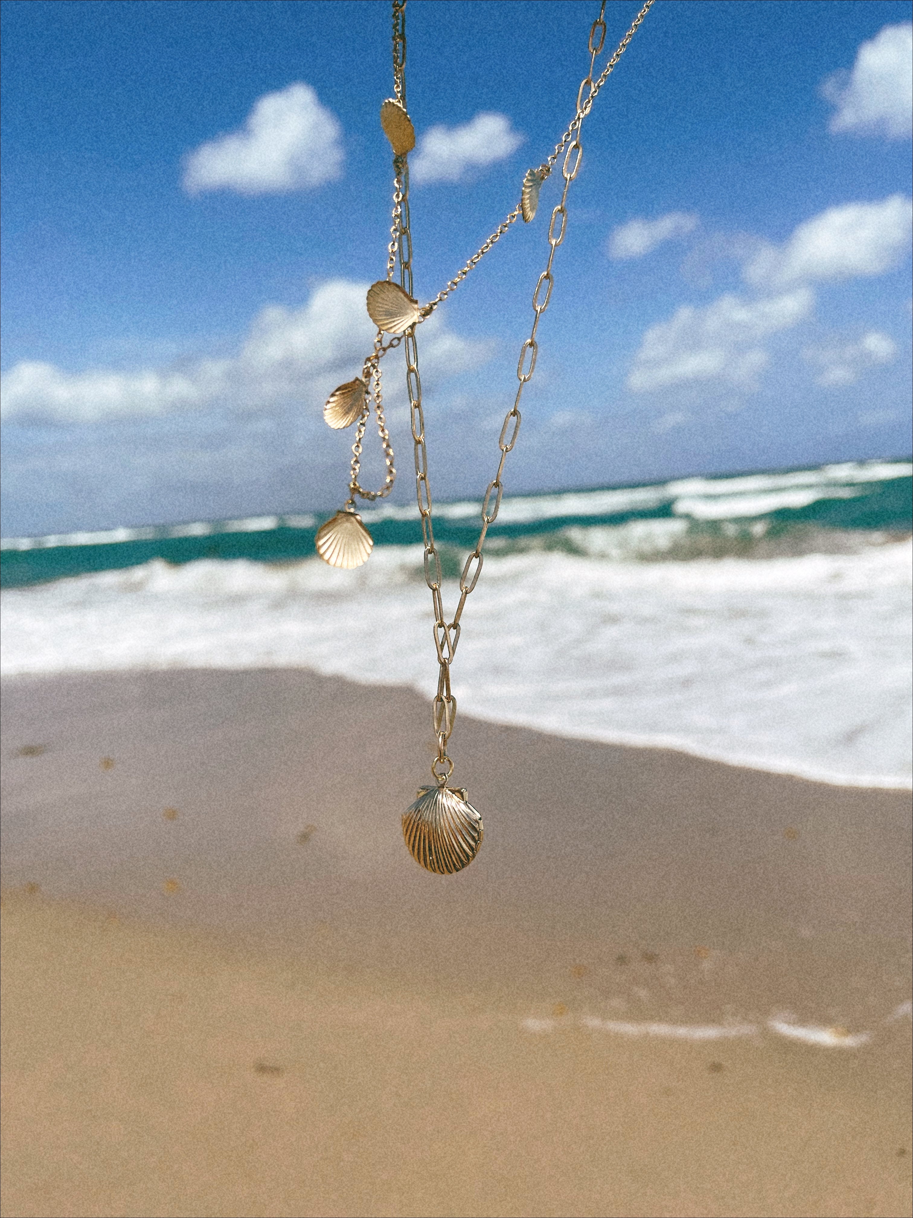 Isla 5 Gold Scallop Seashell Charm on Gold Chain Necklace at the Beach